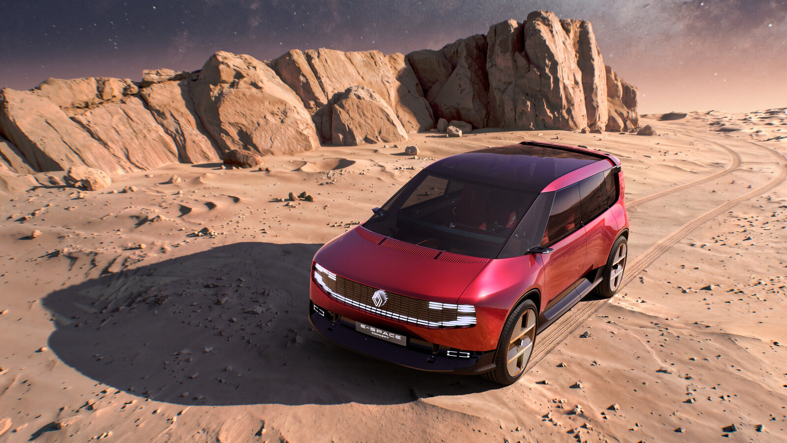 Le Renault E-Space Concept rouge vu de trois quarts avant dans un décor de rochers et de sable